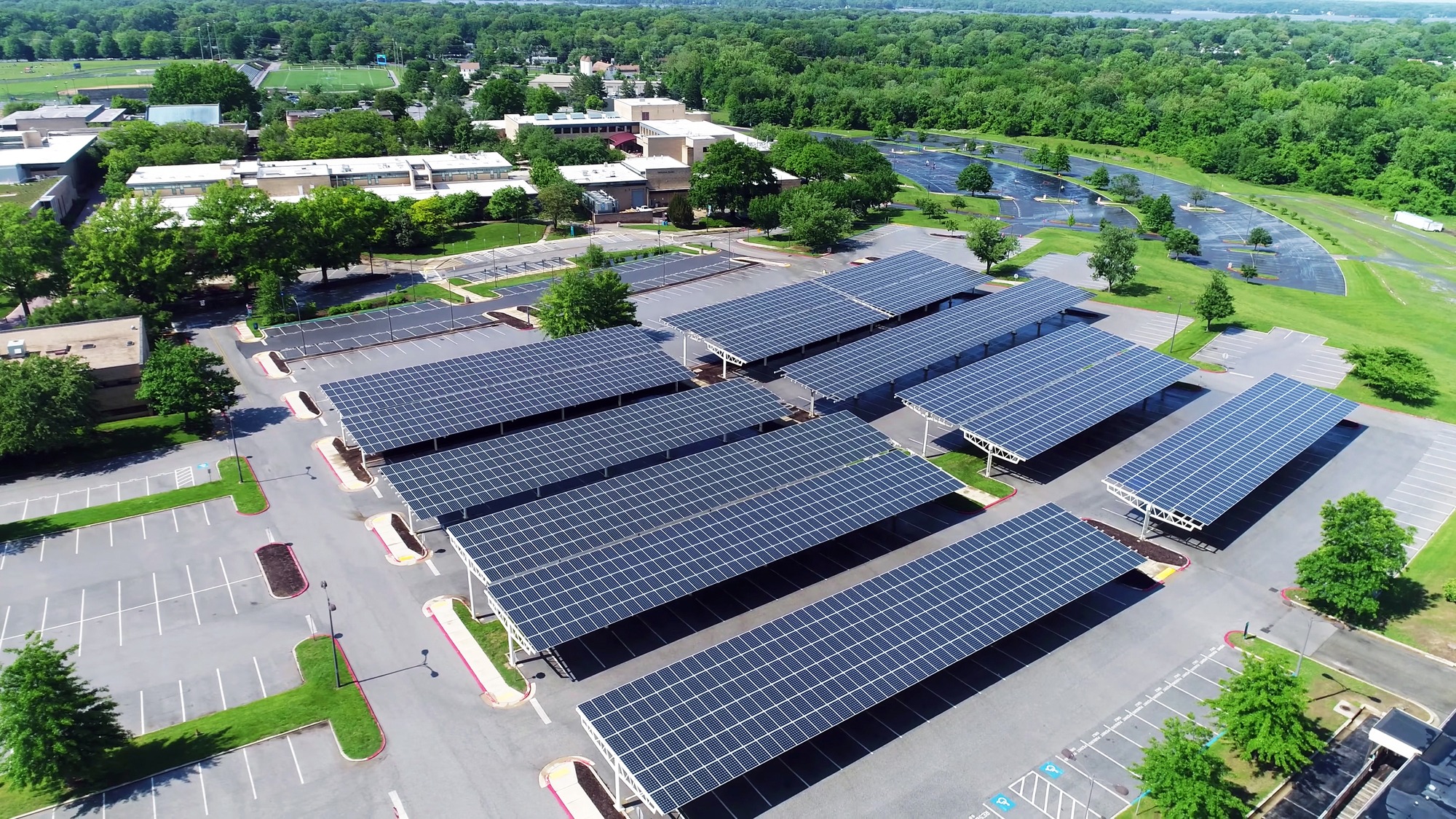 An aerial view of a large solar panel installation in a rural area.