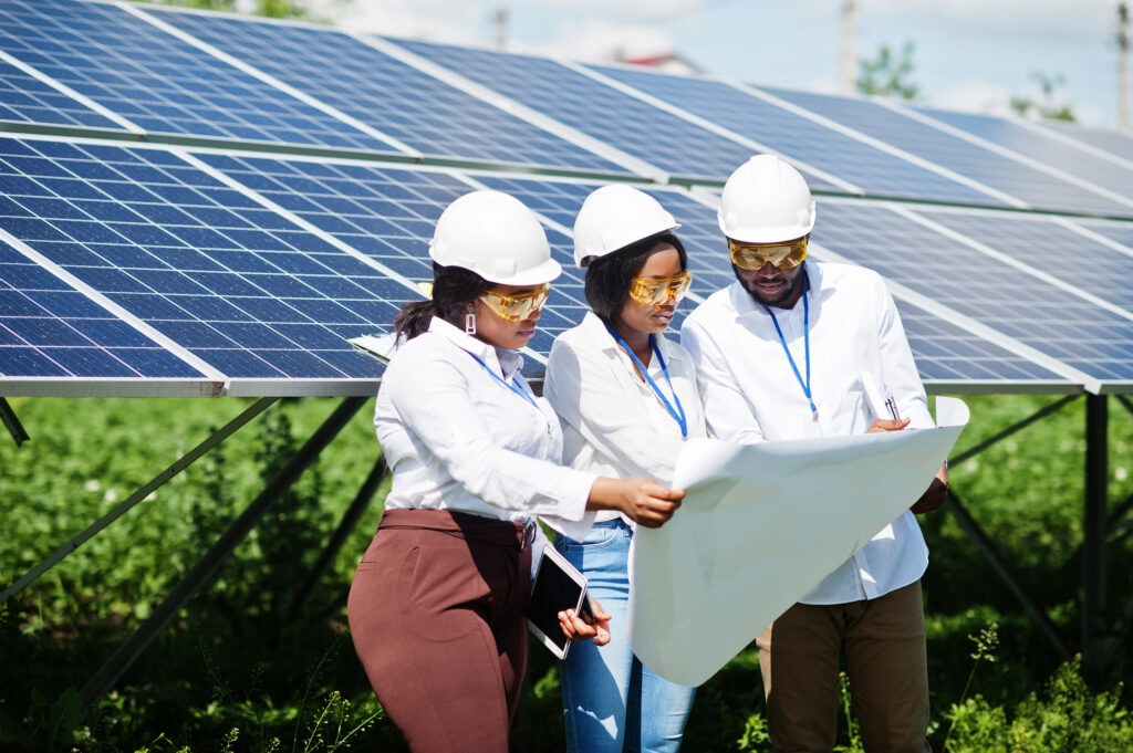 A technician inspecting solar panels on a commercial building.